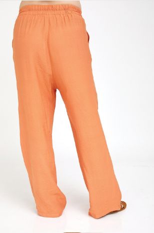 אישה לובשת מכנסי הריון טריסי כתומים